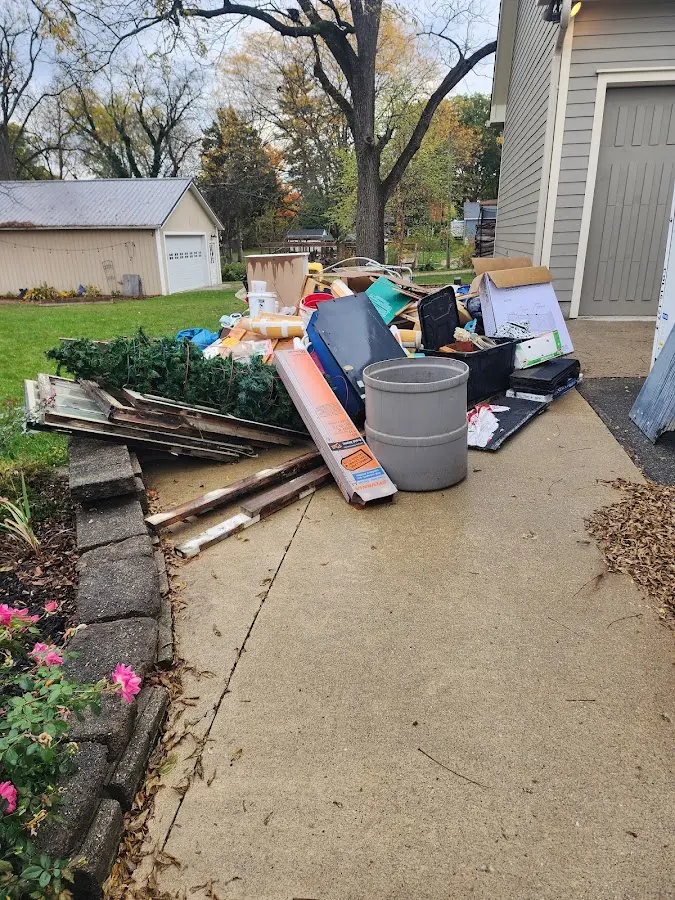 Dumpster being loaded with debris for 3 Yard Dumpster Rental in Round Lake Beach